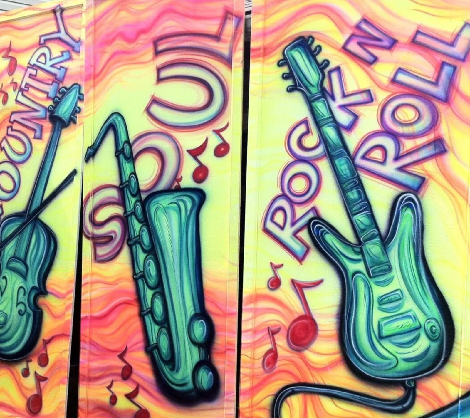 Airbrushed panels of a violin, saxophone, and electric guitar in neon pink, orange, and yellow, labeled Country, Soul, and Rock 'n' Roll